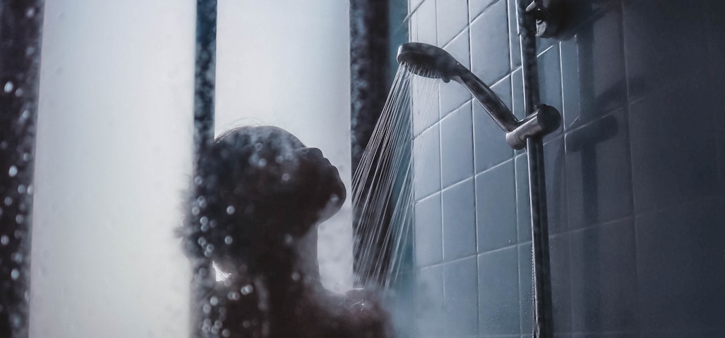 woman under showerhead