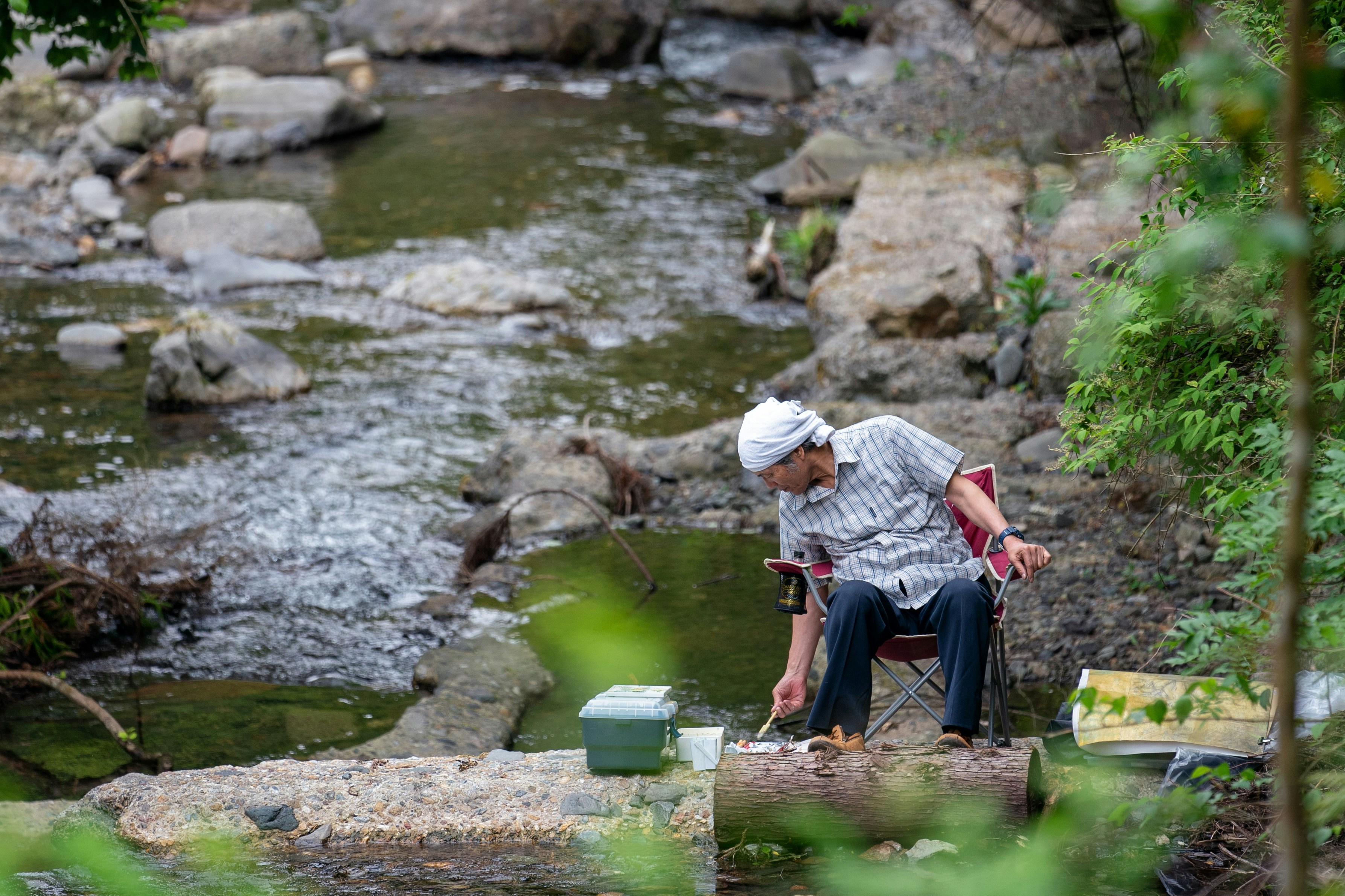 A close-up of an artist painting outdoors.