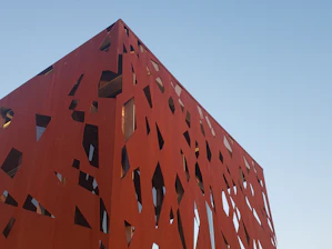 Modern architectural blueprint with rust and concrete color accents.