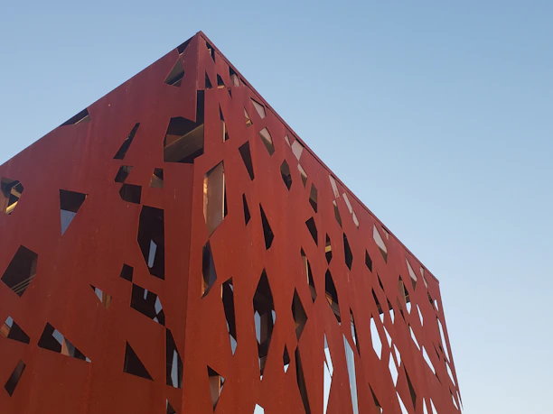 Modern architectural blueprint with rust and concrete color accents.