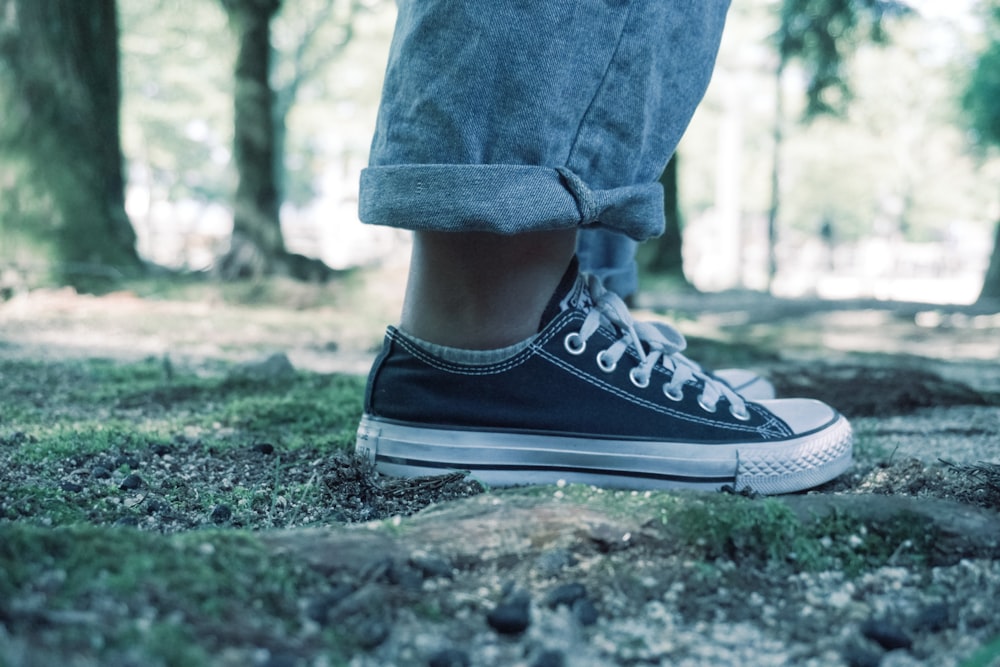 person wearing black low-top sneaker