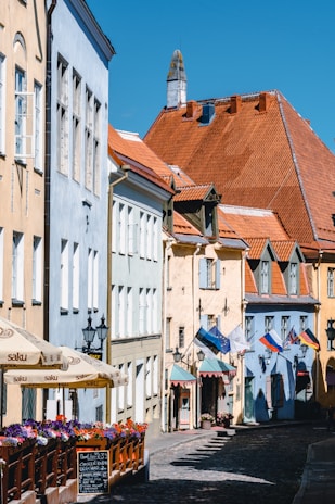 Charming colonial street lined with terracotta buildings and blooming bougainvillea under a clear blue sky.