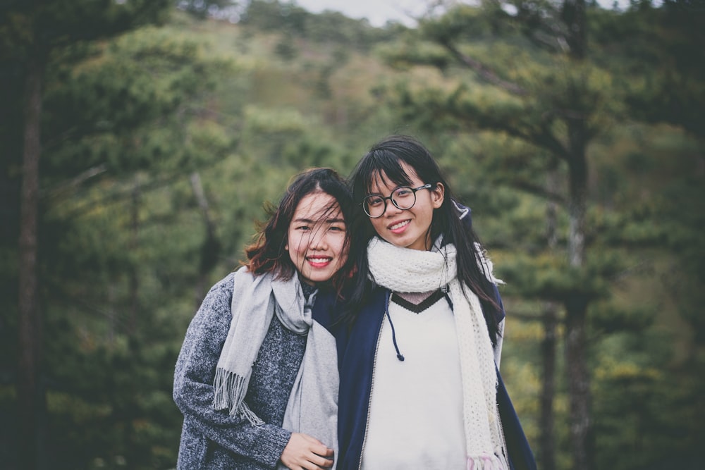 women wearing scarves near trees