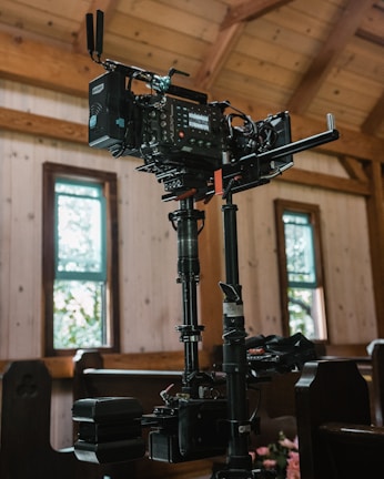 A film crew setting up cameras on an outdoor location during golden hour.