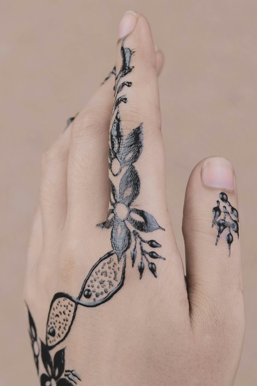 person's left hand with tattoo