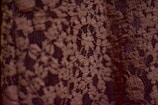 Close-up of a hand-crocheted Irish lace piece with delicate natural fibers.