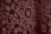 Close-up of delicate fabric textures and fine stitching on a fenluic dress.