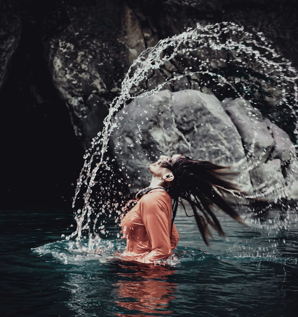 woman bathing on calm water at daytime