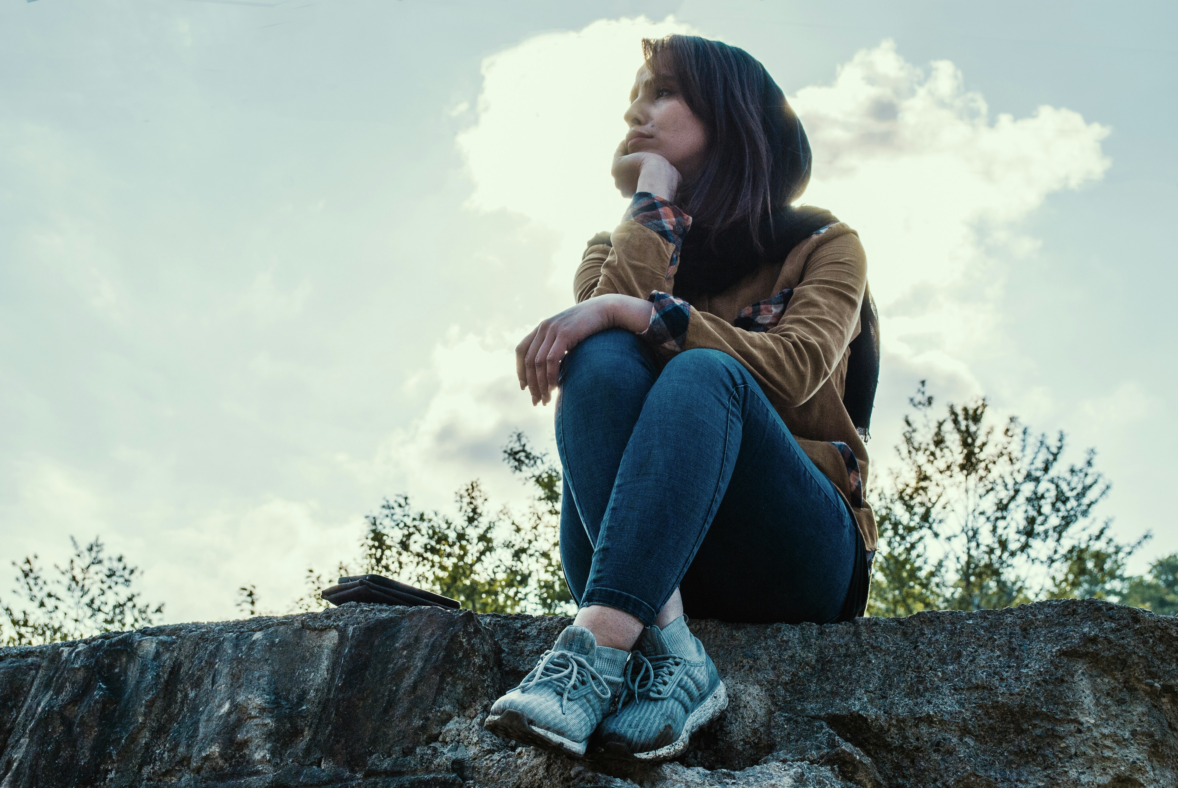 woman sitting on rock