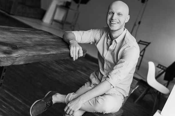 A smiling founder in a cozy office, relaxed and confident, reflecting regained focus.