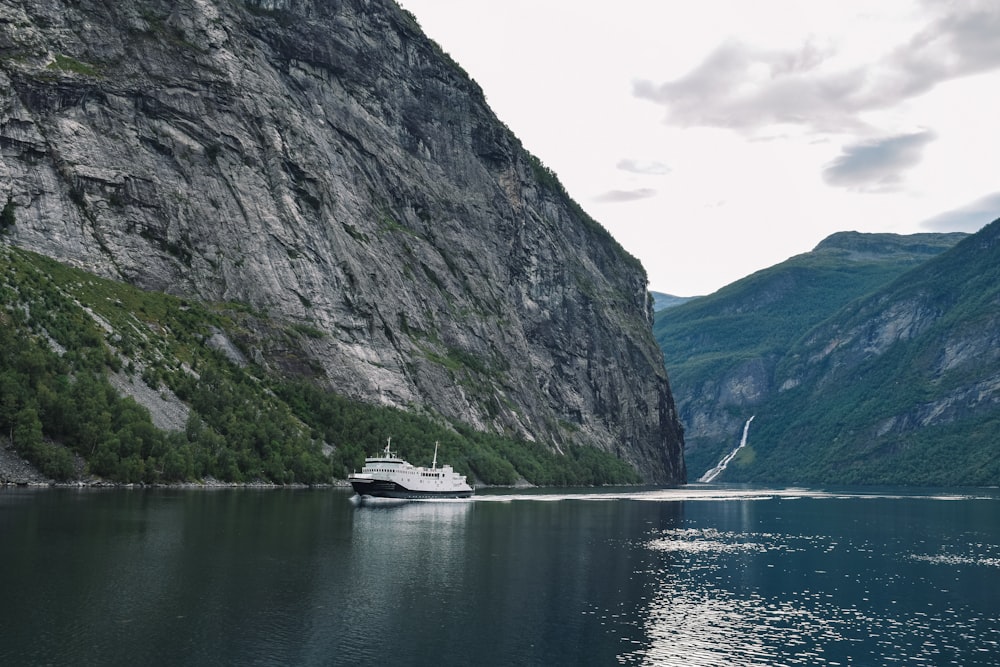 ship on body of water near mountains