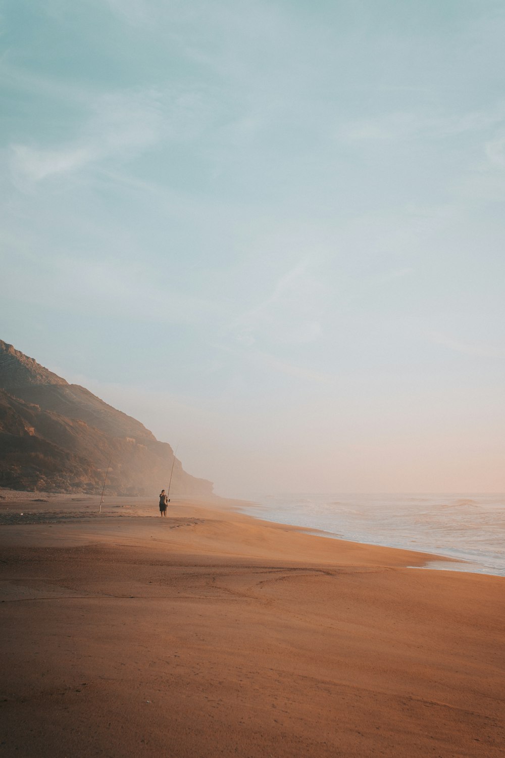 person on sand seashore during day