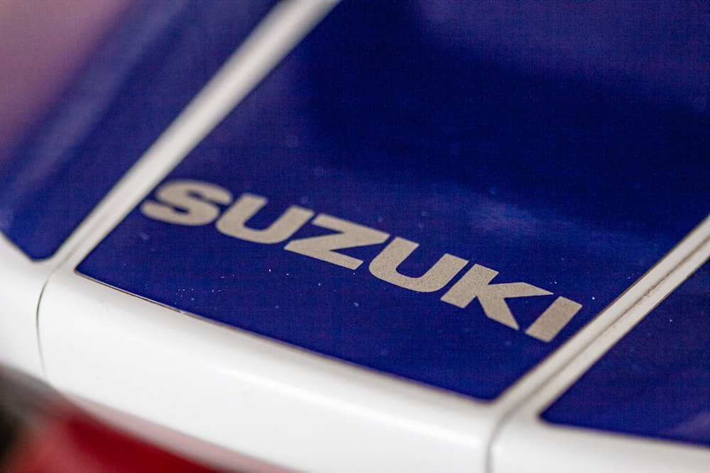 a close up of the suzuki logo on a car