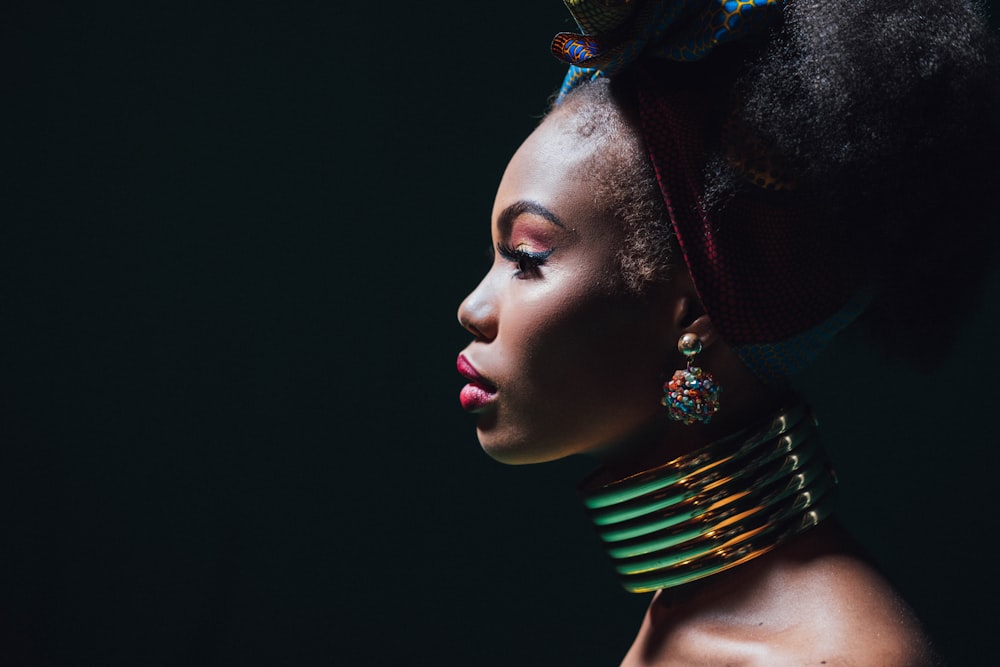 woman wearing gold and green necklace