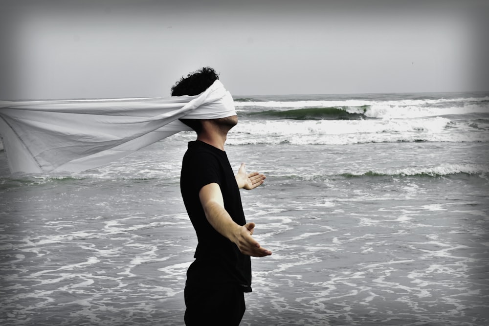 man standing on seashore during daytime