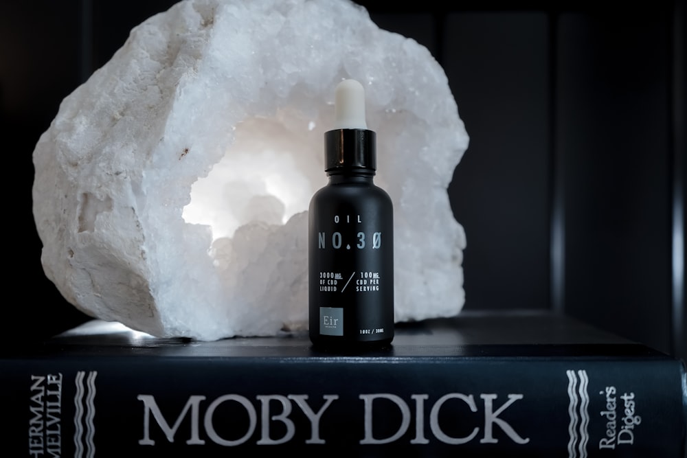 black bottle on Moby Dick book
