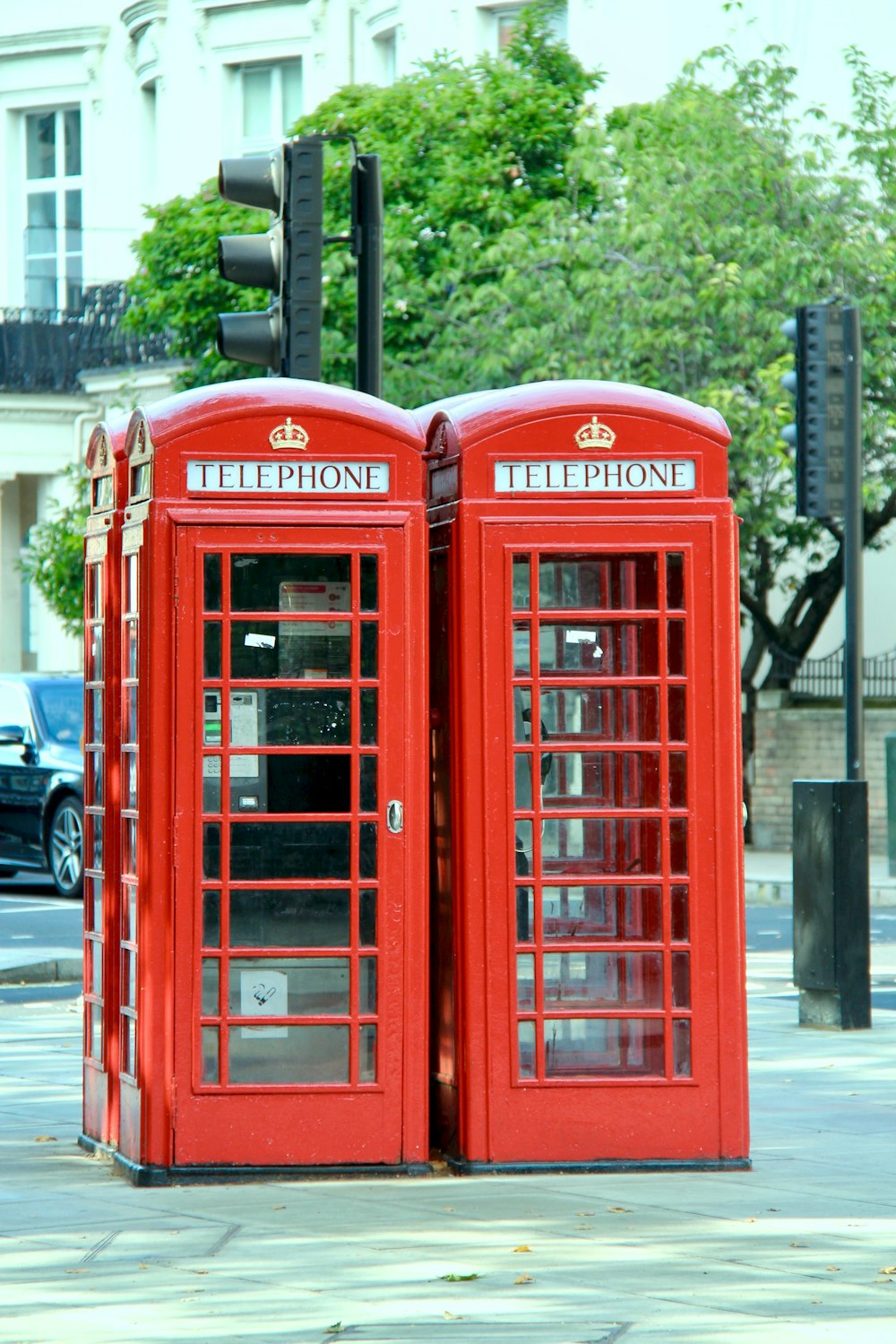 two telephone booths on sidewalk