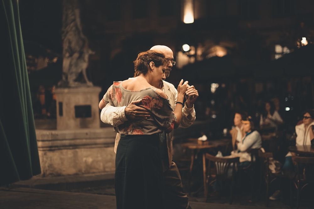 man and woman dancing inside building