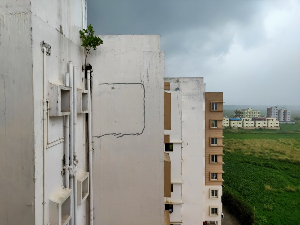 a view of a building with a green field in the background