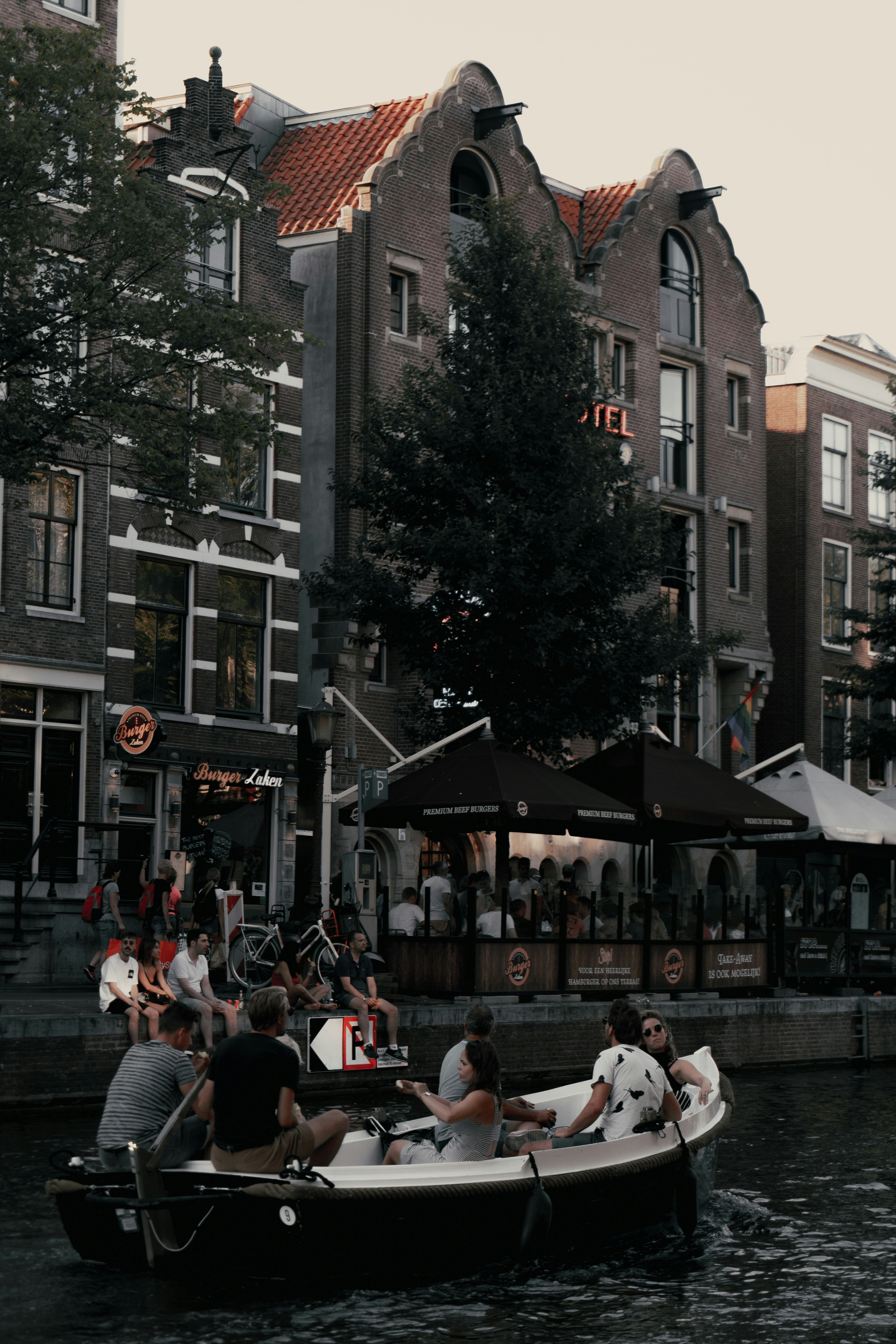 people riding white boat during daytime