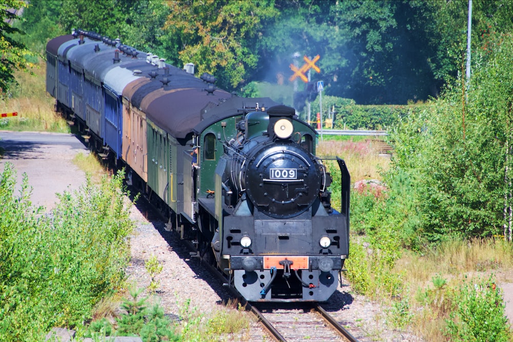 black train crossing street