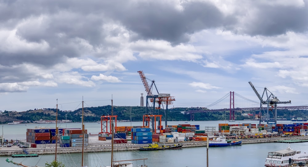 aerial photo of boats near container vans and cranes