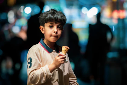 A young customer enjoying an ice cream cone
