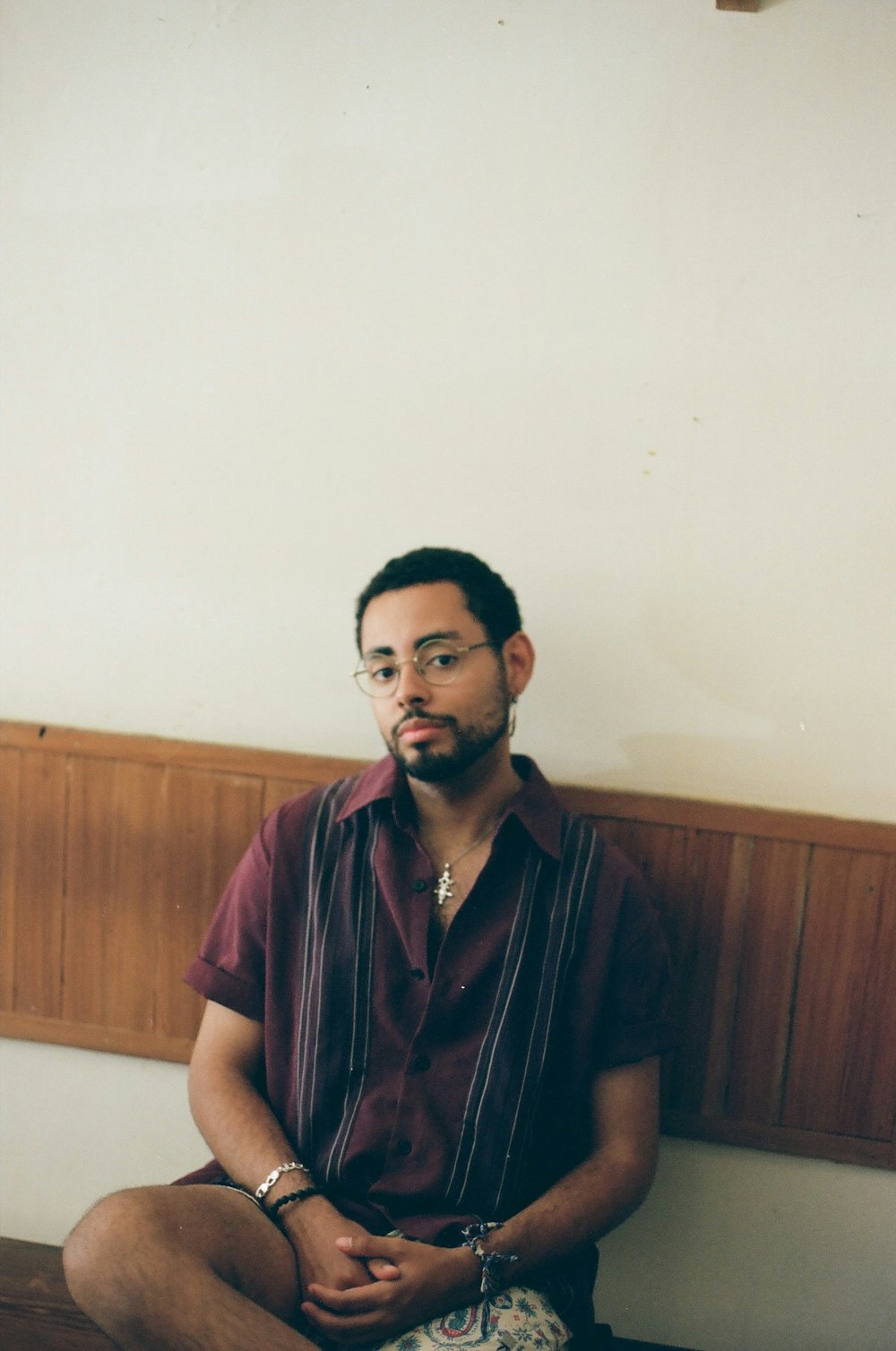 man wearing black framed eyeglasses sitting