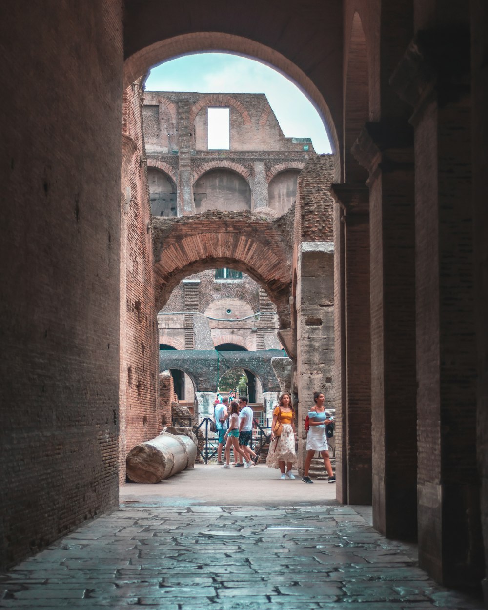 a group of people walking through an archway