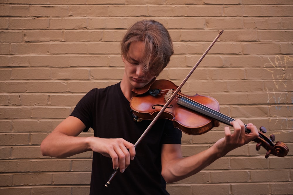 man standing and playing violin