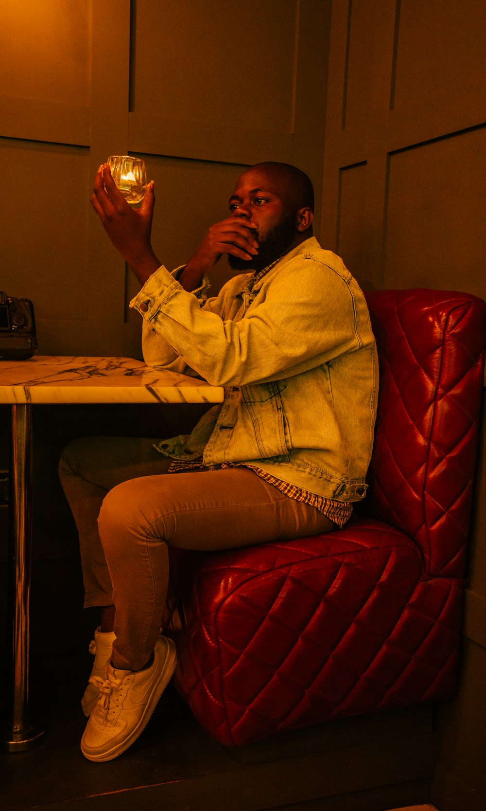 man sitting on red sofa