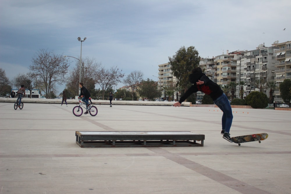 man riding at black and brown skateboard