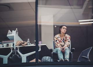 woman sitting on chair beside table