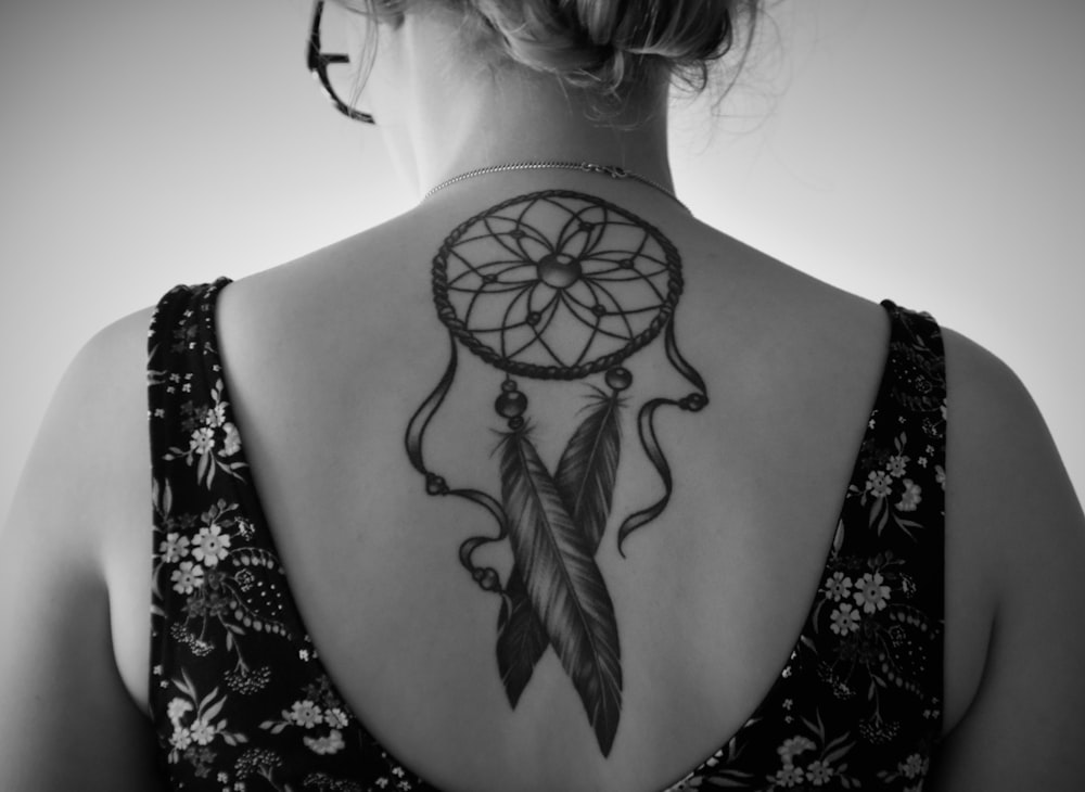 woman with dream catcher tattoo on her back