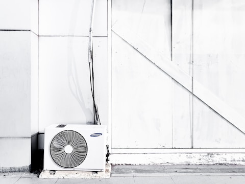 grayscale photography of outdoor AC unit