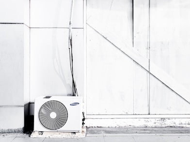 grayscale photography of outdoor AC unit
