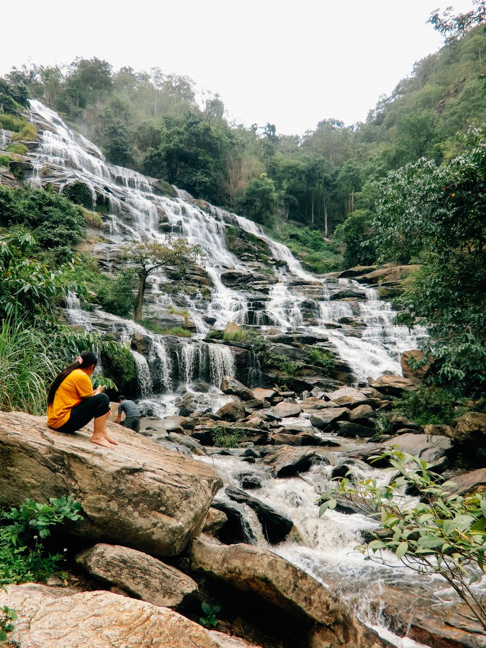 person near waterfalls