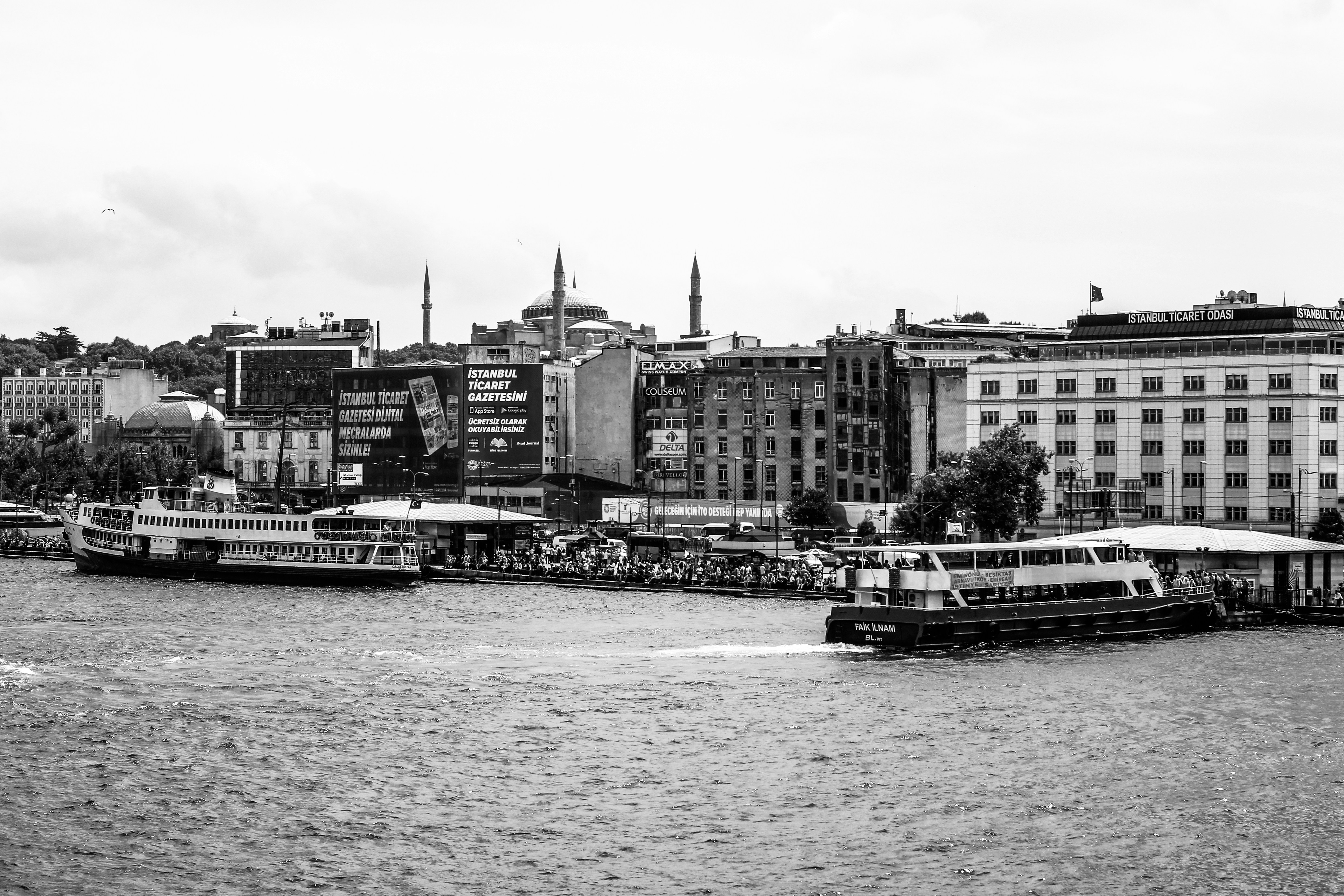passenger boats on sea besude house