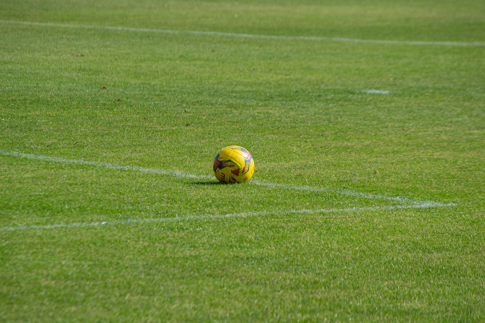 yellow soccer ball on field