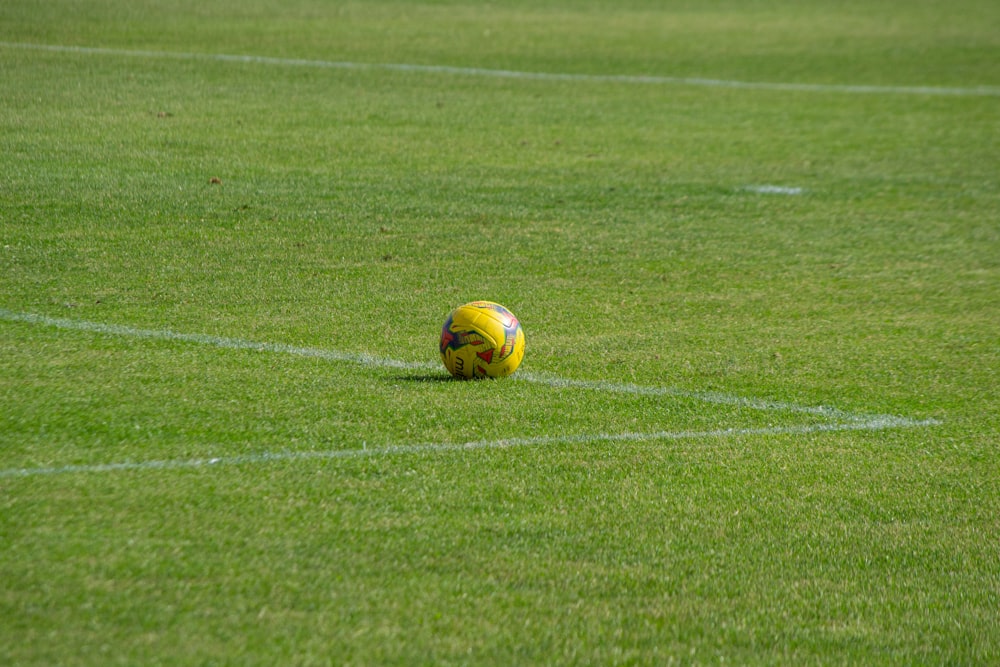yellow soccer ball on field