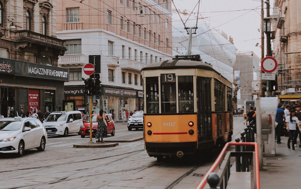 cars and tram on road