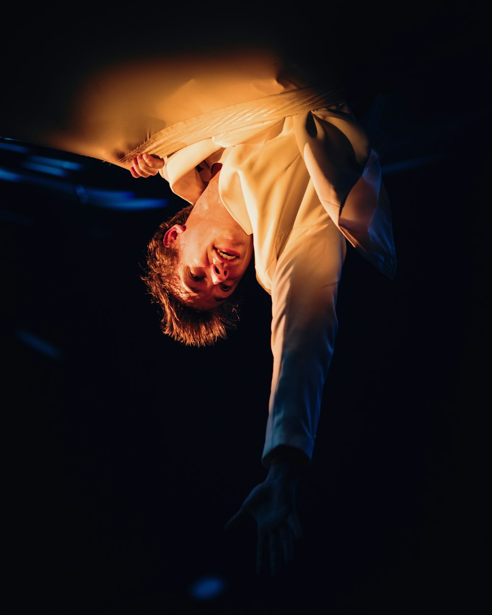 a man is upside down in the dark