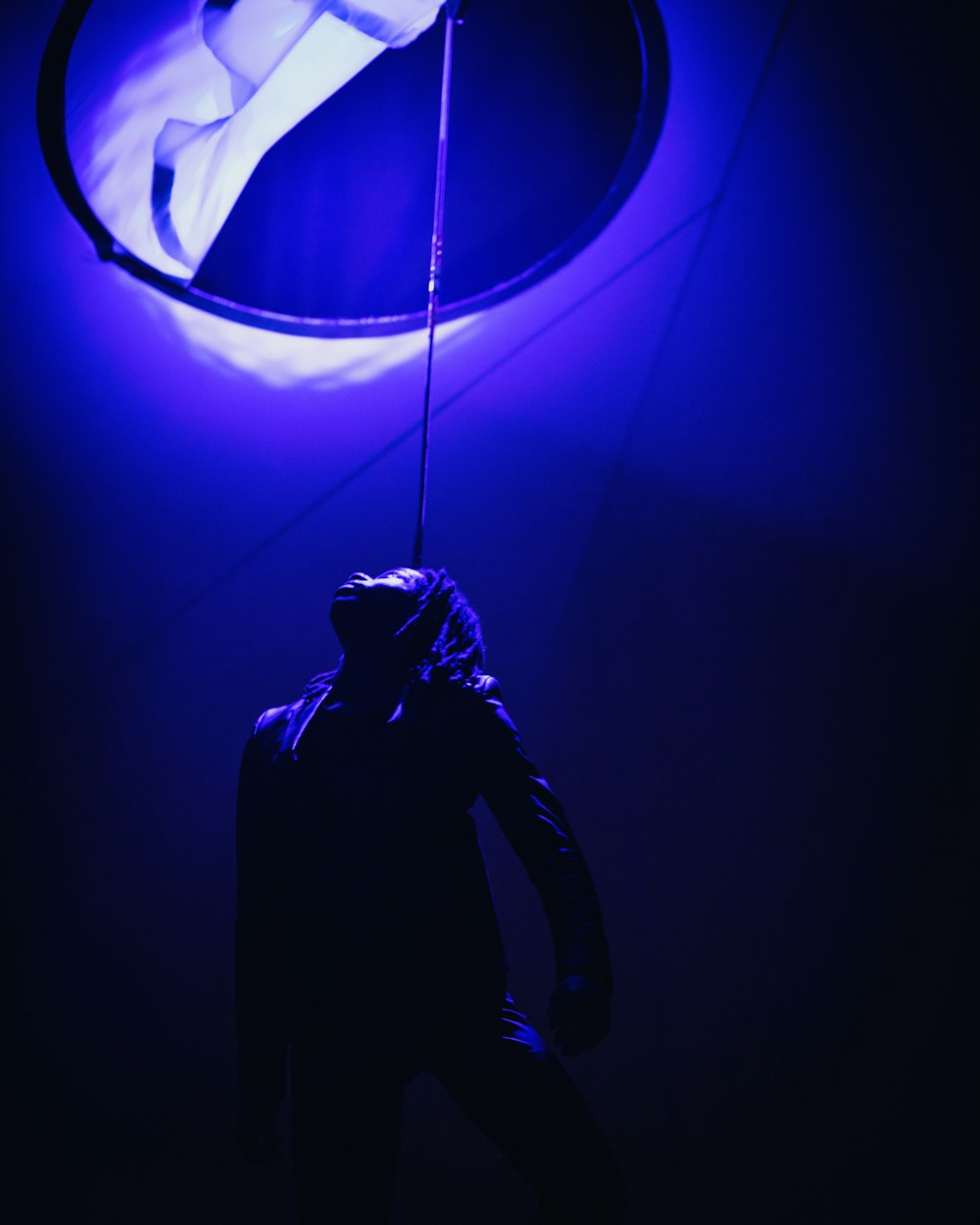a person standing in front of a blue light