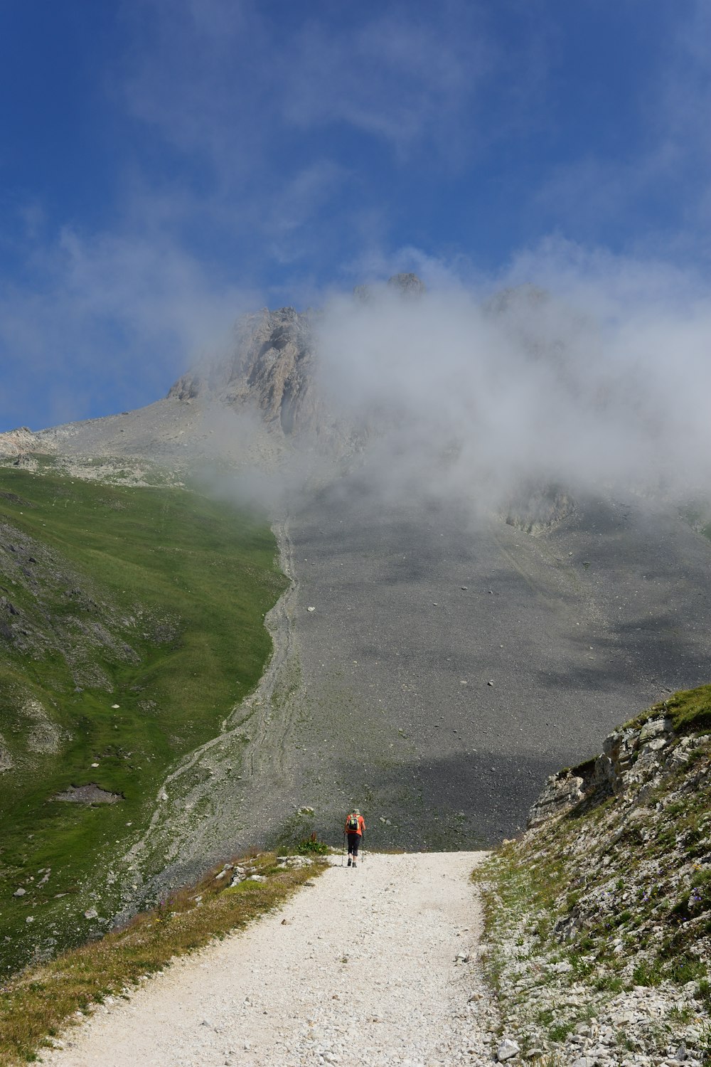 person walking on rough road in the mountain