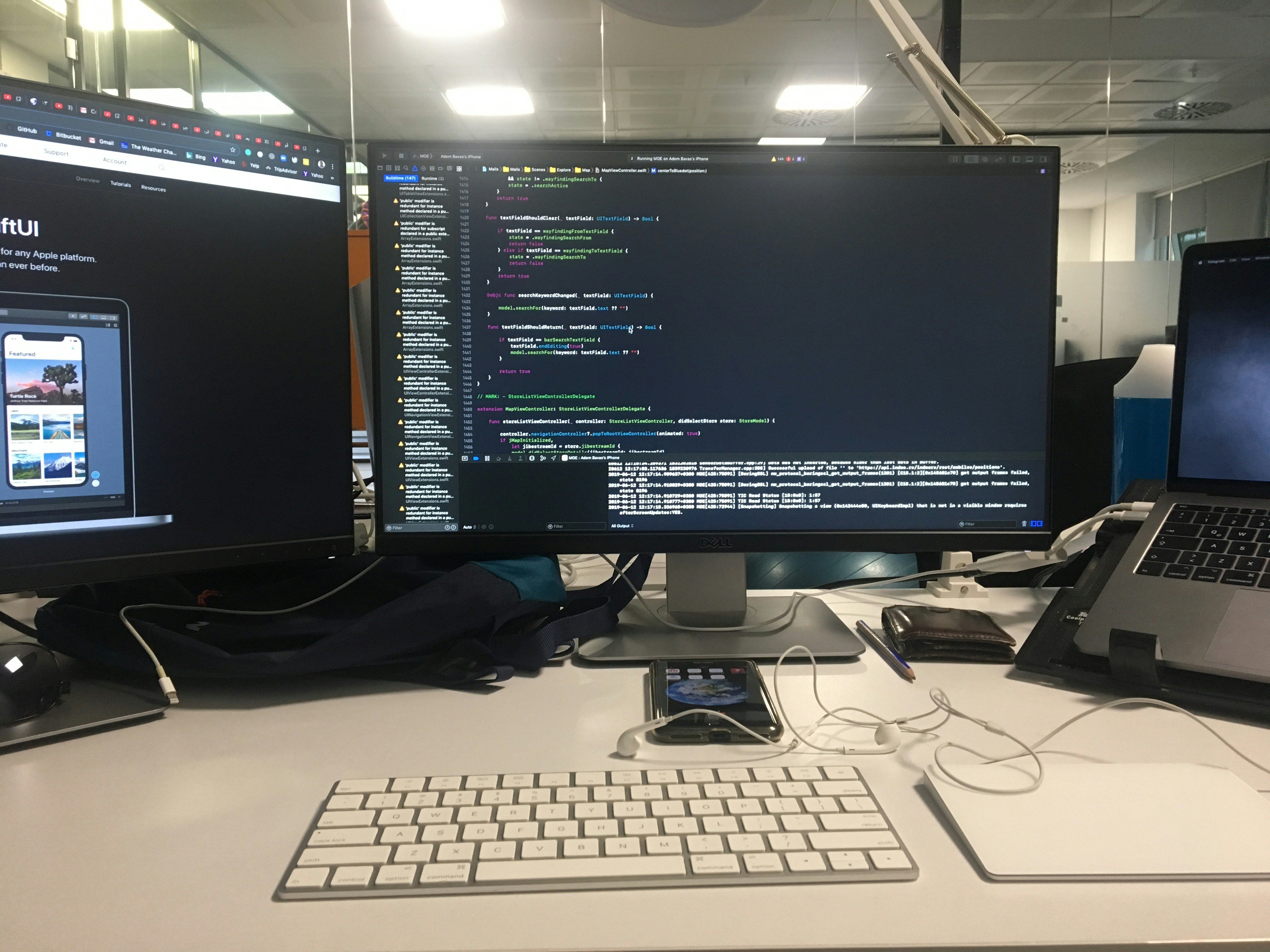 Software developers working on custom application development with multiple monitors showing code and design interfaces