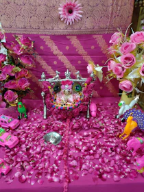 A cozy altar with crystals, candles, and tarot decks bathed in soft pink and golden hues.