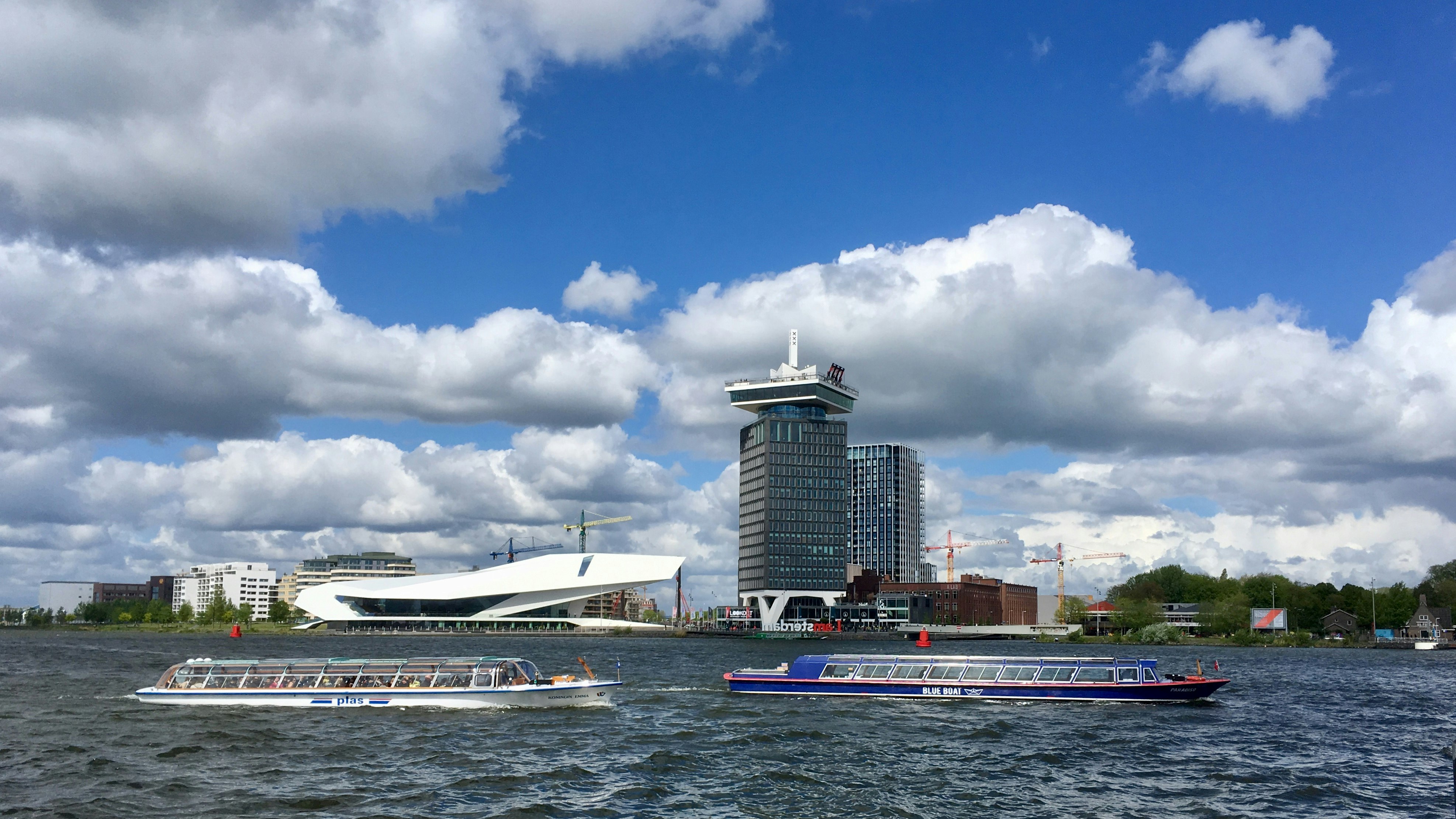 The futuristic white building in the back is the Eye museum in Amsterdam. The high tower on the right you could dine in the top roof restaurant with a beautiful view of Amsterdam.