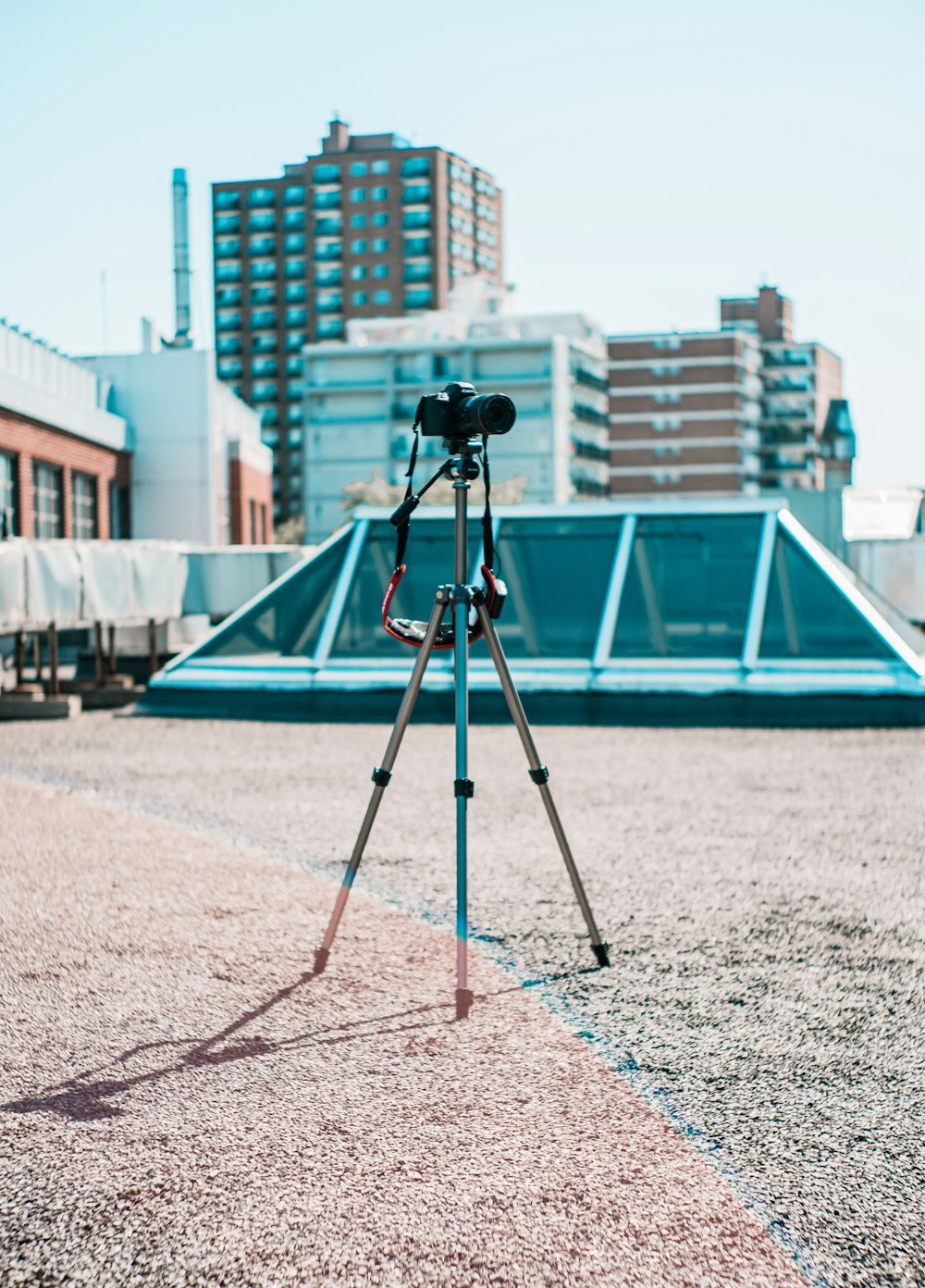 gray tripod near building