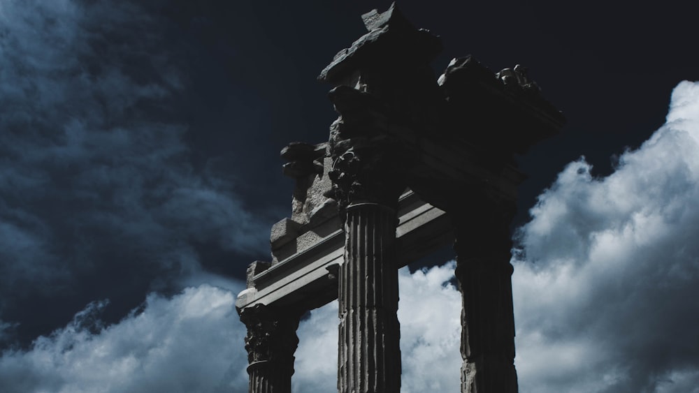 a tall pillar sitting under a cloudy blue sky