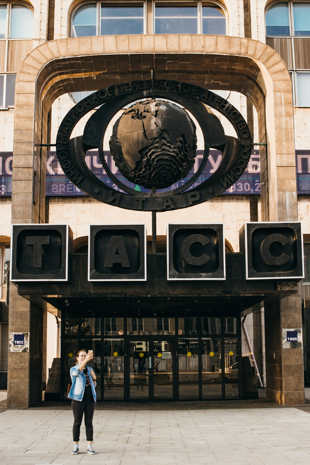 woman standing beside TACC building